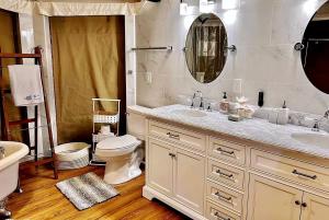 a bathroom with a sink and a toilet and a mirror at Rest and Recharge at this Wonderful Glamping Destination in Burnet, Texas in Marble Falls +32 photos