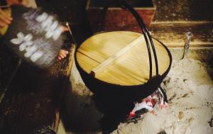 a wooden umbrella sitting on top of a grill at 銭がめ in Kanazawa