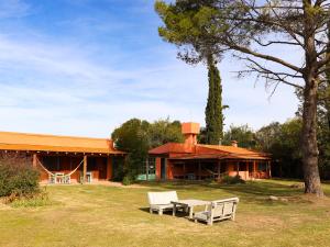 a house with a picnic table in front of it at Posada Buen Camino in Nono