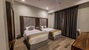 Ένα ή περισσότερα κρεβάτια σε δωμάτιο στο دارنا بلص للشقق المخدومة +14 φωτογραφίες