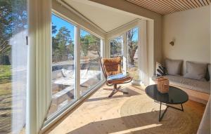 a living room with a chair and a table at Beautiful Home In Gressvik in Gressvik