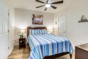 a bedroom with a bed and a ceiling fan at Smith Mountain Lake Retreat with Resort Amenities! in Huddleston +37 photos