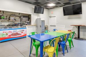 a classroom with a blue table and green chairs at Smith Mountain Lake Retreat with Resort Amenities! in Huddleston