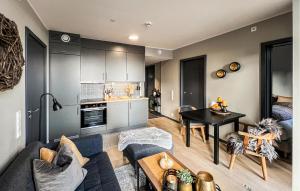 a living room with a couch and a table at 2 Bedroom Awesome Apartment In Sjusjøen in Sjusjøen