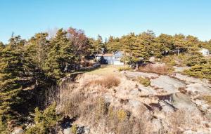 an aerial view of a house on a hill with trees at 5 Bedroom Lovely Home In Tanumshede in Tanumshede +19 photos