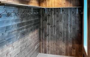a wooden wall with some writing on it at Beautiful Apartment In Idre With Sauna in Idre +8 photos