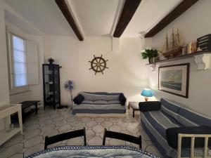 a living room with a couch and a table at Camogli - La casa di Ric - Liguria Holidays in Camogli