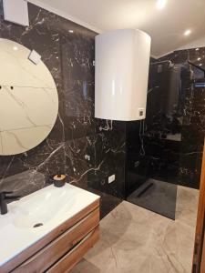 a bathroom with a sink and a mirror at Green view apartment in Koper