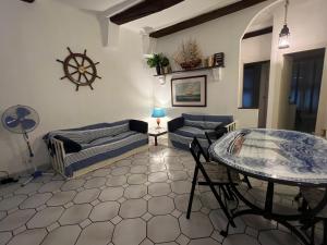 a living room with a couch and a table at Camogli - La casa di Ric - Liguria Holidays in Camogli
