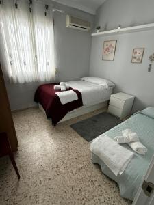 a bedroom with two beds and a window at Like Home in Dos Hermanas +28 photos
