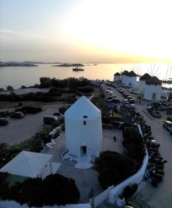 an aerial view of a parking lot with a white building at She Mykonos - The Iconic Windmill in Megali Ammos