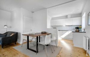 a kitchen with a table and chairs in a room at 2 Bedroom Amazing Home In Ringkøbing in Ringkøbing
