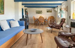 a living room with a blue couch and a table at 1 Bedroom Gorgeous Home In Spøttrup in Spottrup