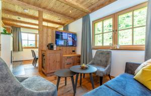 a living room with a couch and a tv at Ferienhaus Whirlpool Und Sauna in Grossarl
