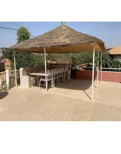a gazebo with a table and chairs under it at Agréable Villa LuLu sur la côte - La Somone in Ngaparou