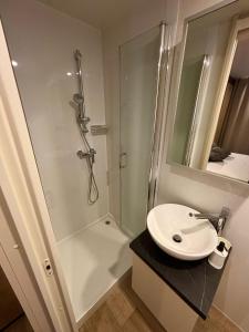 a bathroom with a shower and a white sink at Mobile homes Eva in Biograd na Moru