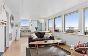 a living room with a couch and a table at 2 Bedroom Stunning Home In Øster Assels in Øster Assels