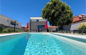 une piscine avec de l'eau bleue devant un immeuble dans l'établissement Amazing Home In Liznjan, à Ližnjan