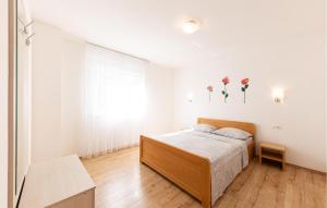 a white bedroom with a bed and a window at Gorgeous Apartment In Duce With Wifi in Duće