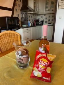 a table with a drink and a bottle of hot sauce at La Colline Stavelot in Stavelot +20 photos
