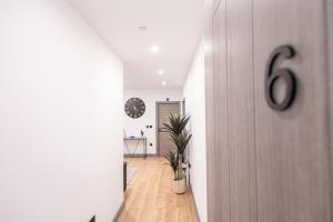 a hallway with a number on the door at Chic 2King BD Apt London with Ensuite & Pull Out Bed in Finchley