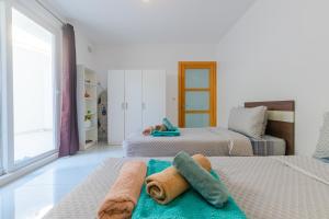 a bedroom with two beds with towels on them at New Spacious Apartment 3 Bdr 2 Bth Bugibba S in St Paul's Bay