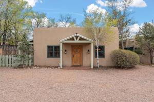 a house with a brown door in a driveway at 654 W San Francisco in Santa Fe
