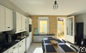 a kitchen with a table and a dining room at Villa Les Pieds dans l'Eau - 4chambres 10personnes - Central & Proche Mer in Le Portel