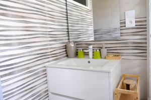 a bathroom with a white sink and a mirror at Evasion Marine, Cozy home in Criel-sur-Mer +25 photos