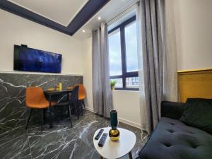 a living room with a couch and a table at luxury Apartament TD one bedroom in Sofia