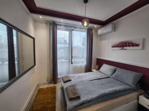 a bedroom with a bed and a large window at luxury Apartament TD one bedroom in Sofia