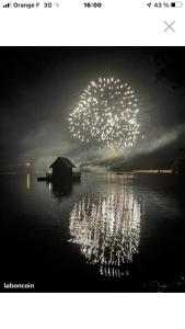 a firework display in the sky over a body of water at Martinique in Saint-Gérons