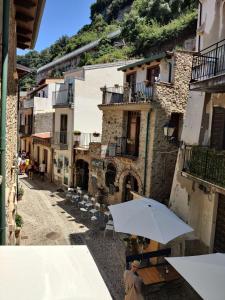 a person standing under an umbrella in an alley at Casa Vacanze Mannara in Scilla