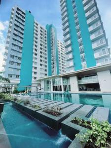 a swimming pool in front of some tall buildings at Bacolod Condo CASA LEA in Bacolod