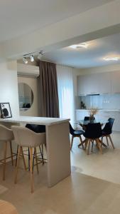 a kitchen and living room with a table and chairs at Milto's Apartment in Limenaria +19 photos