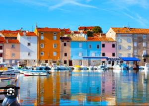 a group of boats docked in a harbor with buildings at Sončen apartma Novigrad in Novigrad Istria