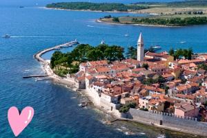 an island in the middle of the water with a pink heart at Sončen apartma Novigrad in Novigrad Istria +7 photos