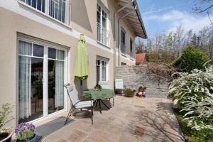 ブルンタールにあるFerienwohnung Alpencityのパティオ(テーブル、緑の傘付)