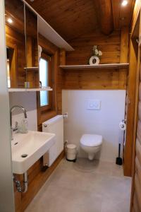 a bathroom with a white sink and a toilet at Marlies - Lastering Ferienhäuser & Apartments in Wettringen