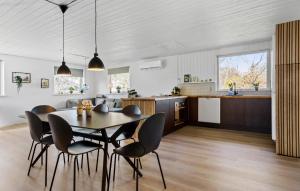 a kitchen and dining room with a table and chairs at Cozy Home In Ebeltoft With Wifi in Ebeltoft