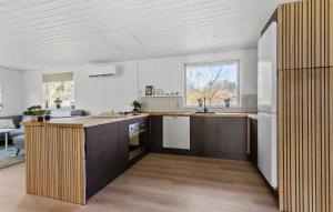 a kitchen with a counter top and a refrigerator at Cozy Home In Ebeltoft With Wifi in Ebeltoft +14 photos