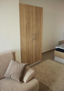a living room with a couch and a cabinet at Apartment Vyhlídka in Mikulov