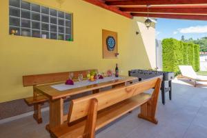 a dining room with a bench and a table at Villa Dajana, a cozy pet friendly Villa minutes from the beach in Juršići