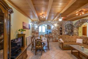 a living room with a couch and a table at Villa Dajana, a cozy pet friendly Villa minutes from the beach in Juršići