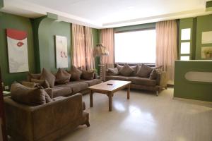 a living room with two couches and a coffee table at Park 12 in Kavaklıdere