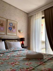 a bedroom with a large bed and a window at Maira House in Platamonas