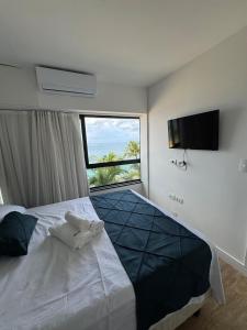 a bedroom with a large bed with a large window at Ondina Apart Hotel 02 quartos Vista Mar in Salvador +68 photos