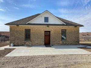 a brick house with a door in the middle at Canyon Acres Ranch in Russell