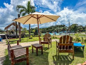 a table and two chairs and an umbrella at Ville Acqua Park in Bragança