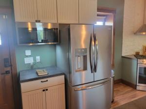 a kitchen with a stainless steel refrigerator at Canyon Acres Ranch in Russell